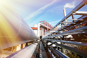 Image showing Industrial zone, Steel pipelines and valves against blue sky