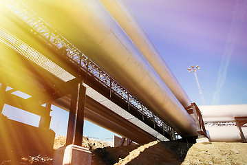 Image showing Industrial zone, Steel pipelines and valves against blue sky