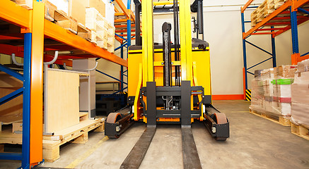 Image showing Forklift, shelves and racks with pallets in distribution warehou