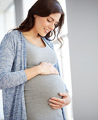 Image showing happy pregnant woman with big tummy at home