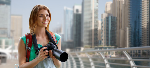 Image showing woman with backpack and camera over dubai city
