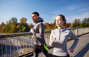 Image showing happy couple running outdoors