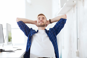 Image showing happy creative man with computer at office