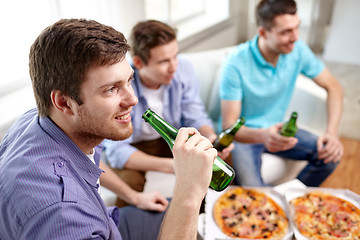 Image showing close up of friends with beer and pizza at home