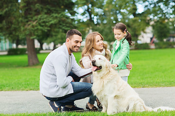 Image showing happy family with labrador retriever dog in park