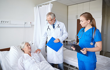 Image showing doctor and nurse visiting senior woman at hospital