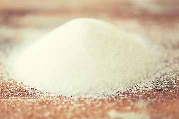Image showing close up of white sugar heap on wooden table