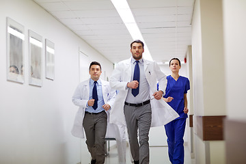 Image showing group of medics walking along hospital