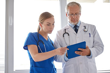 Image showing senior doctor and nurse with tablet pc at hospital