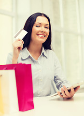 Image showing smiling woman with blank screen tablet pc