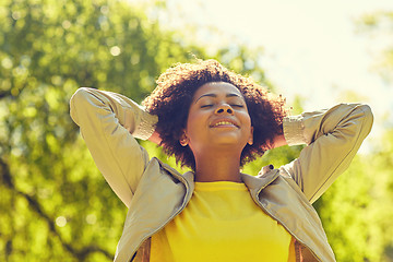 Image showing happy african american young woman in summer park