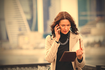 Image showing beautiful middle-aged woman using a smartphone