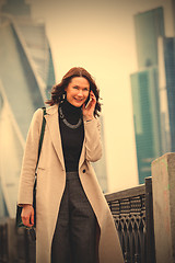 Image showing smiling middle-aged woman talking on a mobile phone