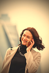 Image showing beautiful smiling woman talking on a mobile phone
