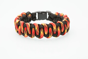 Image showing black and orange braided bracelet on white background