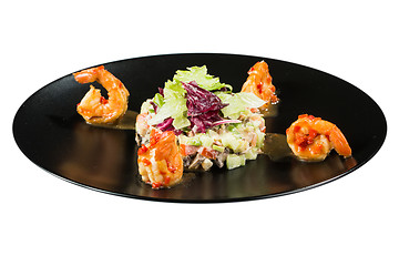 Image showing perfect dish with shrimps on a black plate. seafood. Isolated  white background