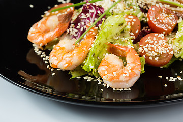 Image showing perfect dish with shrimps on a black plate. seafood