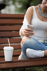 Image showing beautiful girl on the street corresponded by phone. 