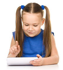 Image showing Young girl is using tablet