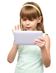 Image showing Young nearsighted girl is using tablet
