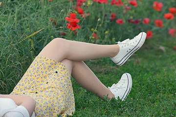 Image showing young girl  lying on field