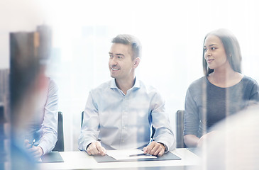 Image showing group of smiling businesspeople meeting in office