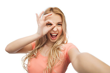 Image showing happy smiling young woman taking selfie