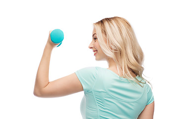 Image showing smiling beautiful young sporty woman with dumbbell