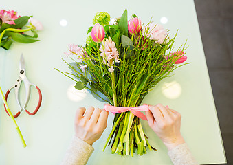 Image showing close up of woman making bunch at flower shop