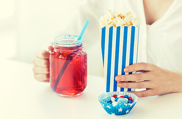 Image showing woman with popcorn and drink in glass mason jar