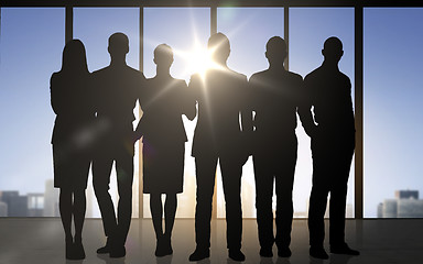 Image showing business people silhouettes over office background