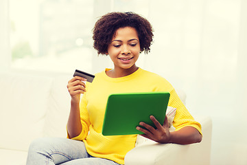 Image showing happy african woman with tablet pc and credit card