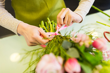 Image showing close up of woman making bunch at flower shop