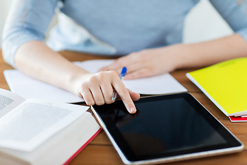 Image showing close up of student with tablet pc and notebook