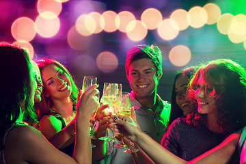 Image showing smiling friends with glasses of champagne in club