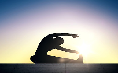 Image showing woman doing exercises on stairs over sun light