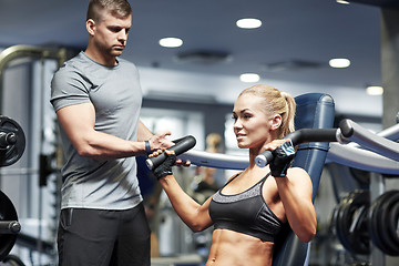 Image showing man and woman flexing muscles on gym machine