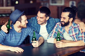 Image showing happy male friends drinking beer at bar or pub