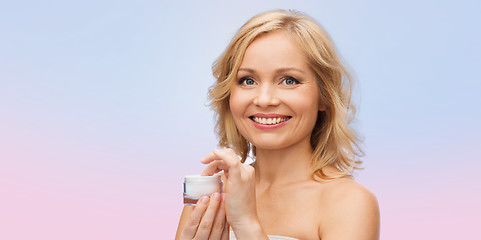 Image showing happy woman with cream jar