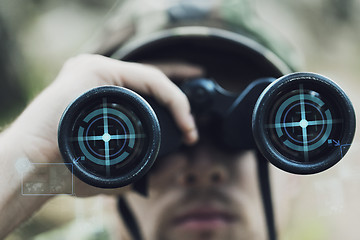 Image showing close up of soldier or hunter with binocular