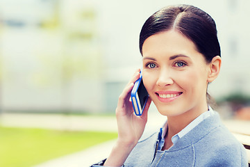 Image showing young smiling businesswoman calling on smartphone