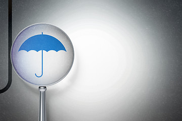 Image showing Security concept:  Umbrella with optical glass on digital background