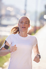 Image showing sporty woman running  on sidewalk