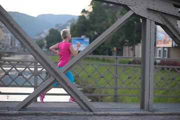 Image showing sporty woman running  on sidewalk