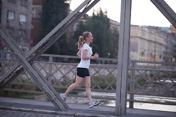 Image showing sporty woman running  on sidewalk