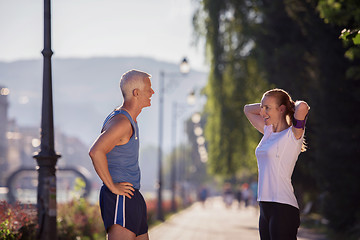 Image showing jogging couple planning running route  and setting music