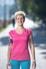 Image showing sporty woman running  on sidewalk