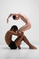 Image showing Couple of ballet dancers posing over gray background