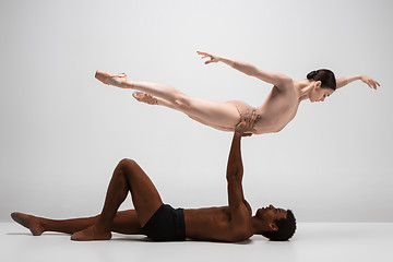 Image showing Couple of ballet dancers posing over gray background