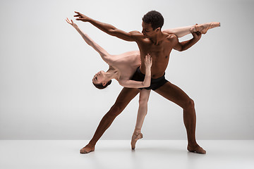 Image showing Couple of ballet dancers posing over gray background